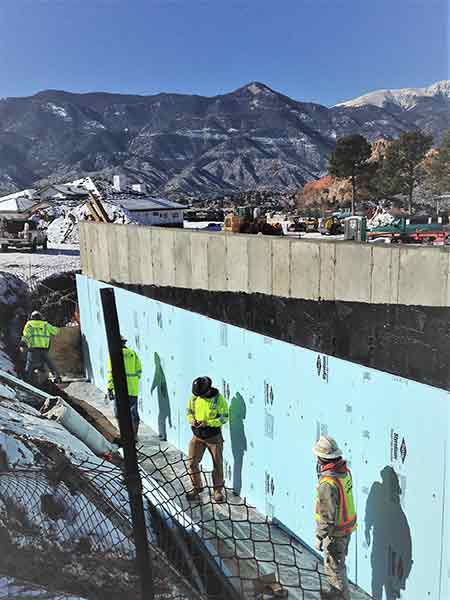 crew working on perimeter drain at foot of mountain range